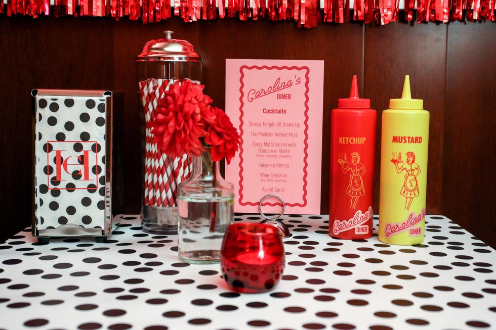 Diner table setup featuring condiments and cocktail menu