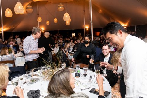 guests enjoy the festivities under the tent on storm king's grounds
