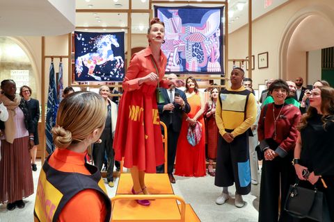 an actress singing in ﻿hermès's ﻿love on the block﻿ musical to celebrate the opening of the new madison avenue flagship