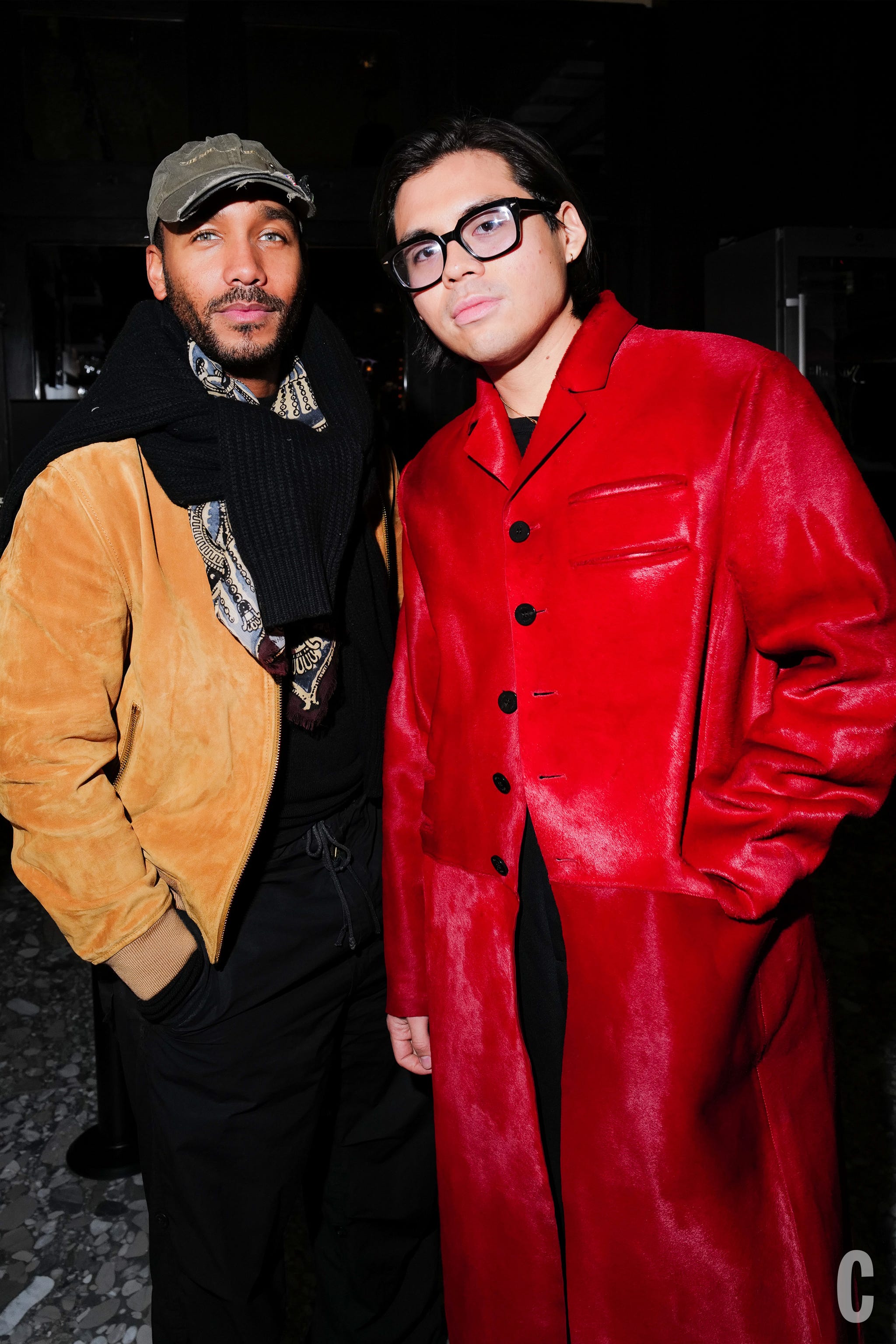 two people in stylish outerwear: one in a red coat and the other in a beige jacket and scarf