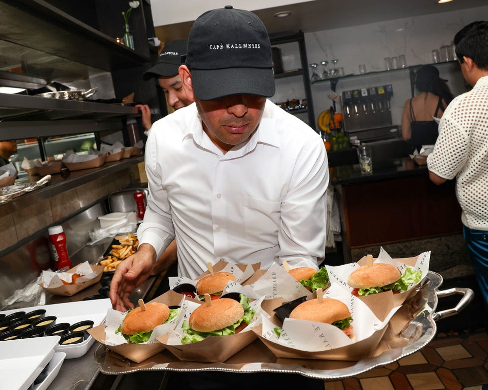 Server carrying a tray of burgers in a restaurant