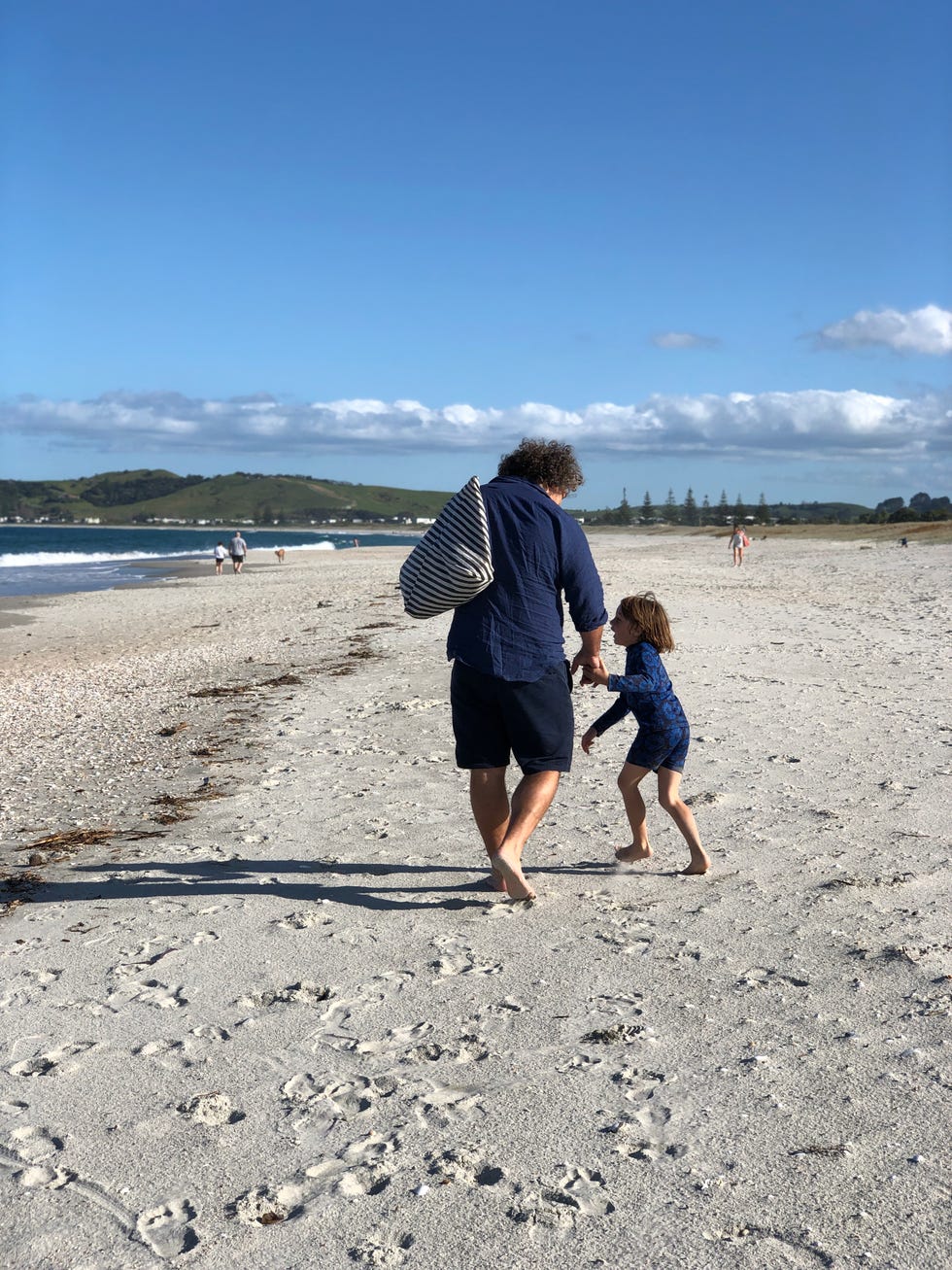 massimo and cian on the beach in omaha, new zealand