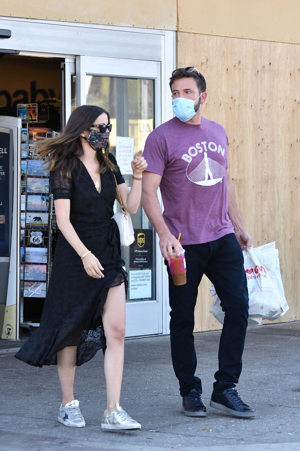 ben and ana walk out of whole foods, carrying a plastic bag