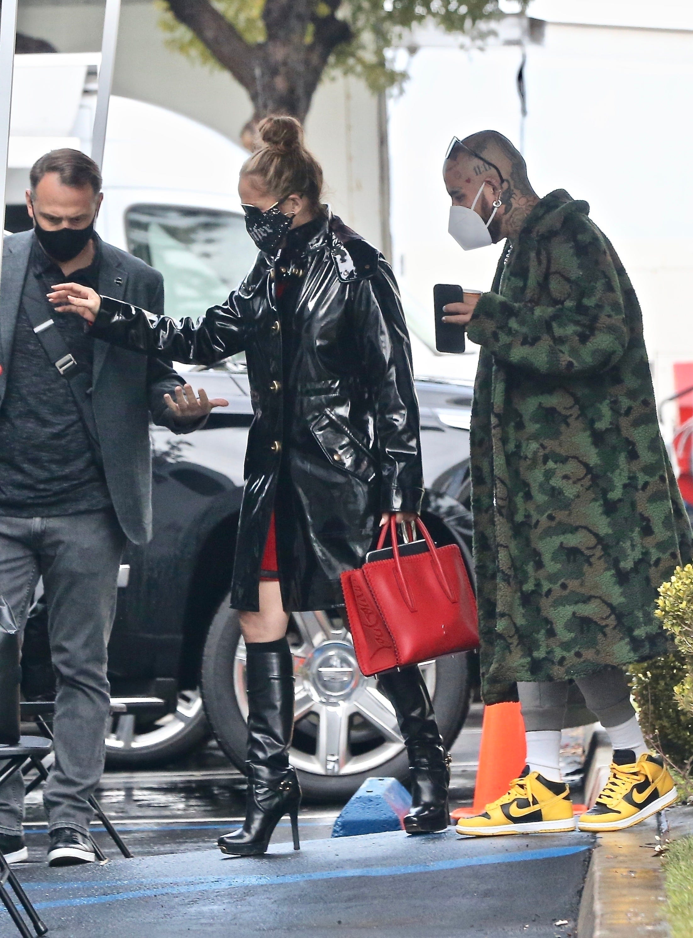 Jennifer Lopez Stuns in a PVC Coat, Stiletto Boots & a Red Dress