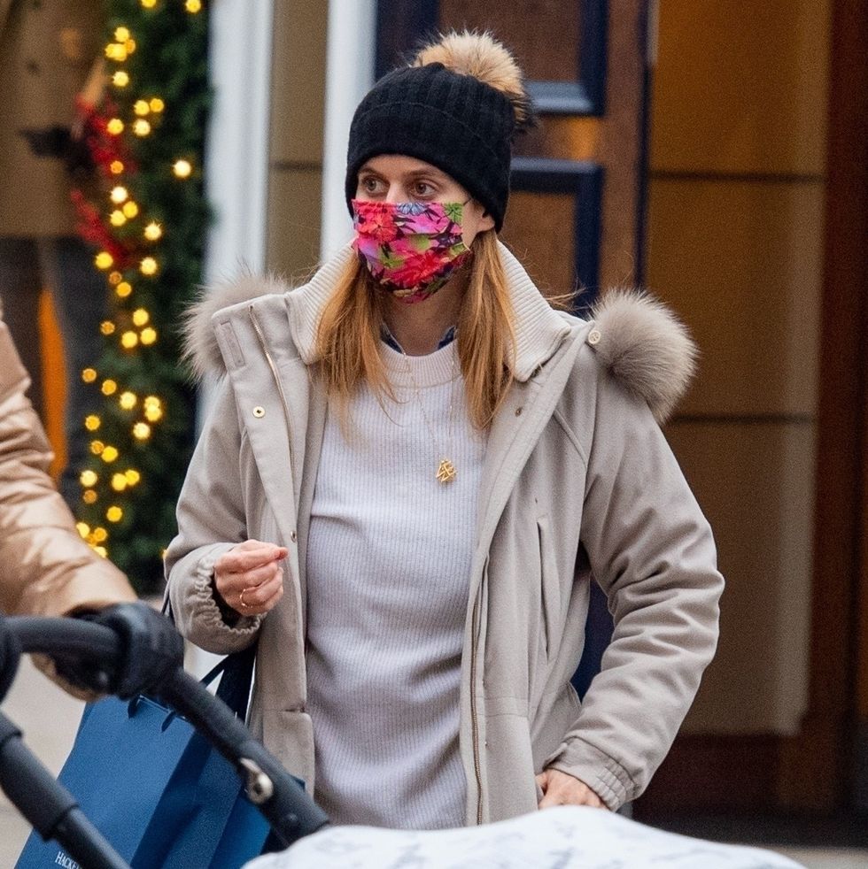 princess beatrice in floral face mask and black beanie walking outside