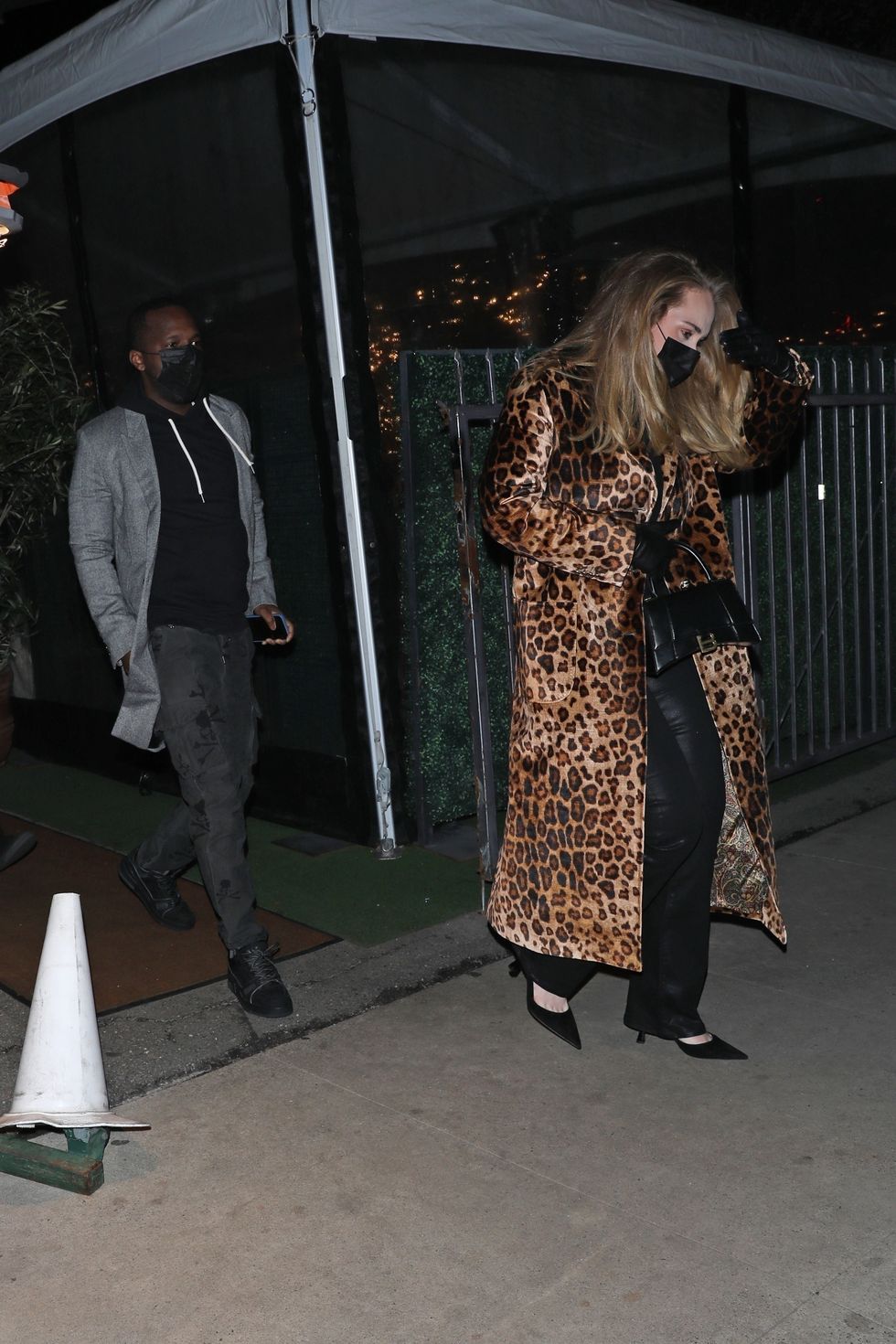 adele and rich paul walk outside, adele wears long cheetah print coat