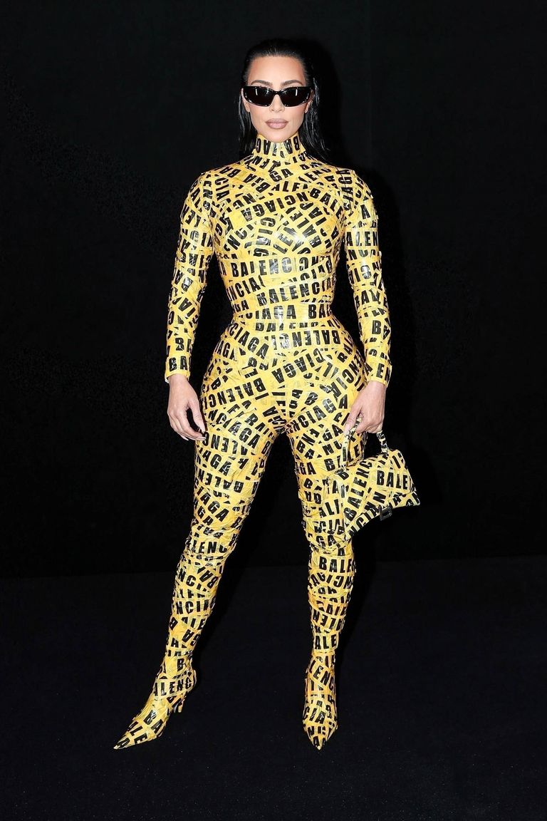 Kim Kardashian Attends Balenciaga Show in Yellow Caution Tape Catsuit