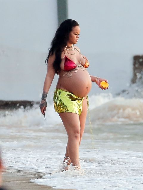 rihanna holds a mango and a knife while wearing sequined bikini at the beach