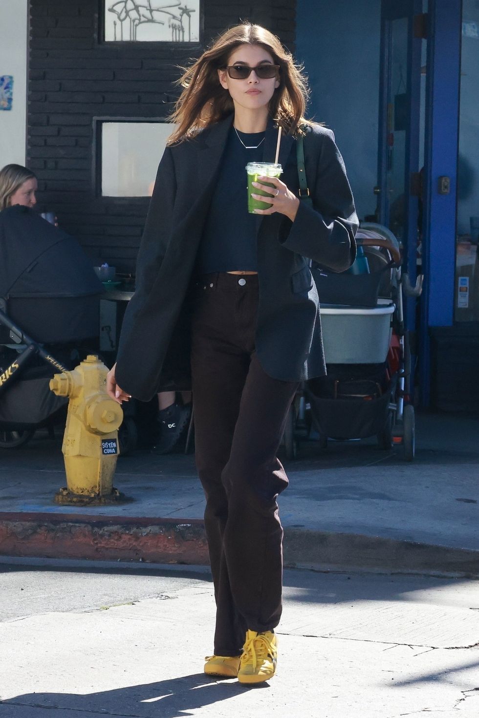 kaia gerber wearing black separates in a story about onitsuka mexico 66 sneakers 2023