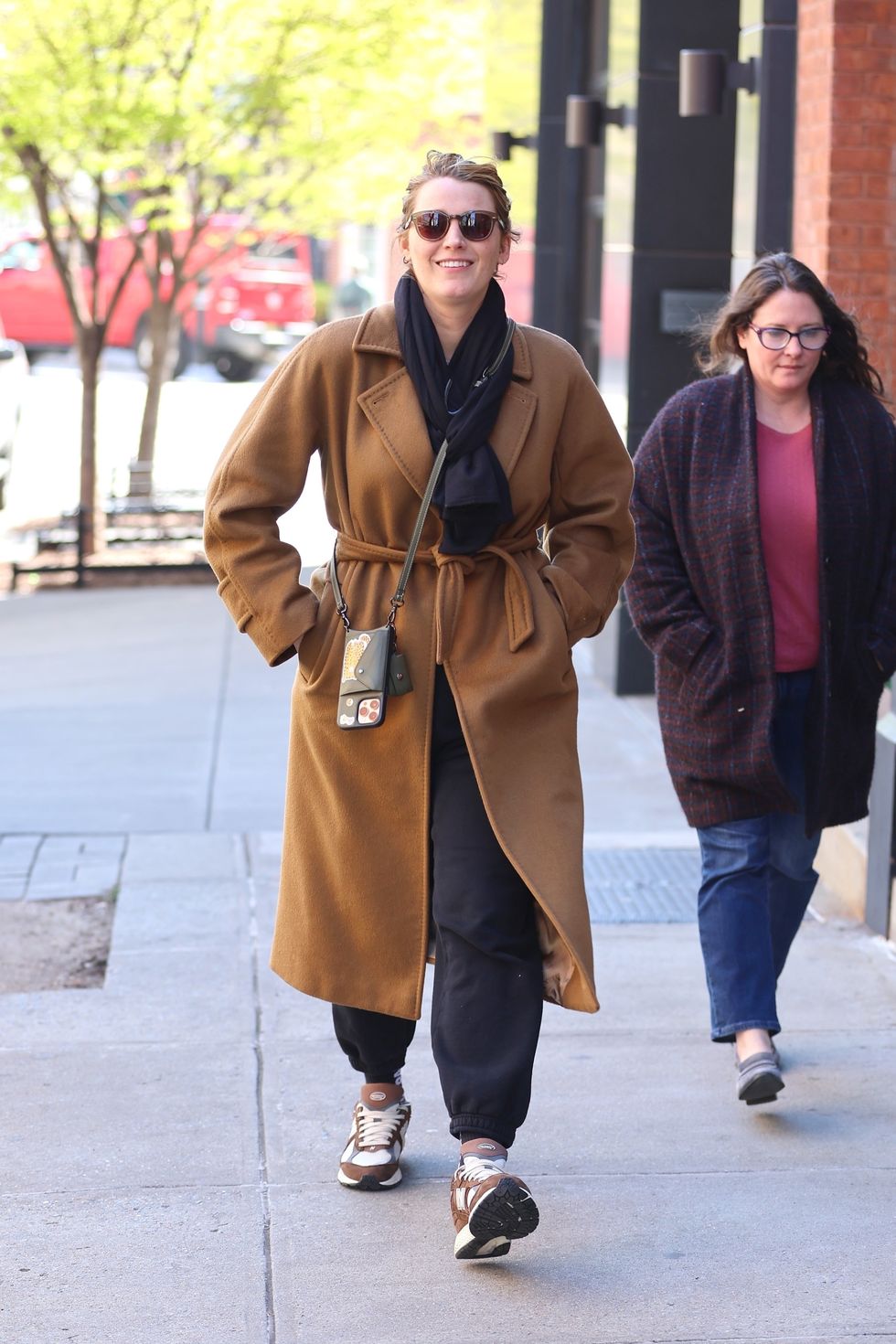 Blake Livelys Casual Off Duty Look Involves A Wrap Coat And Sweatpants 