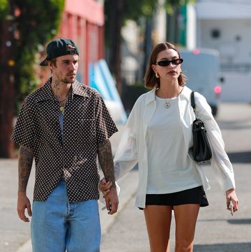 a man and woman walking down a street