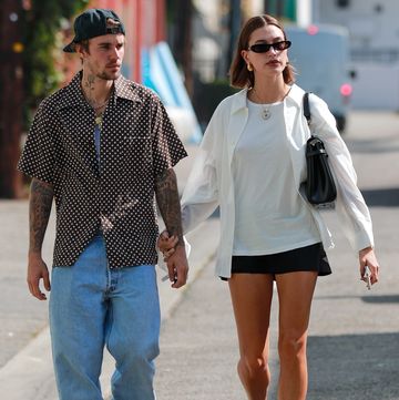 a man and woman walking down a street