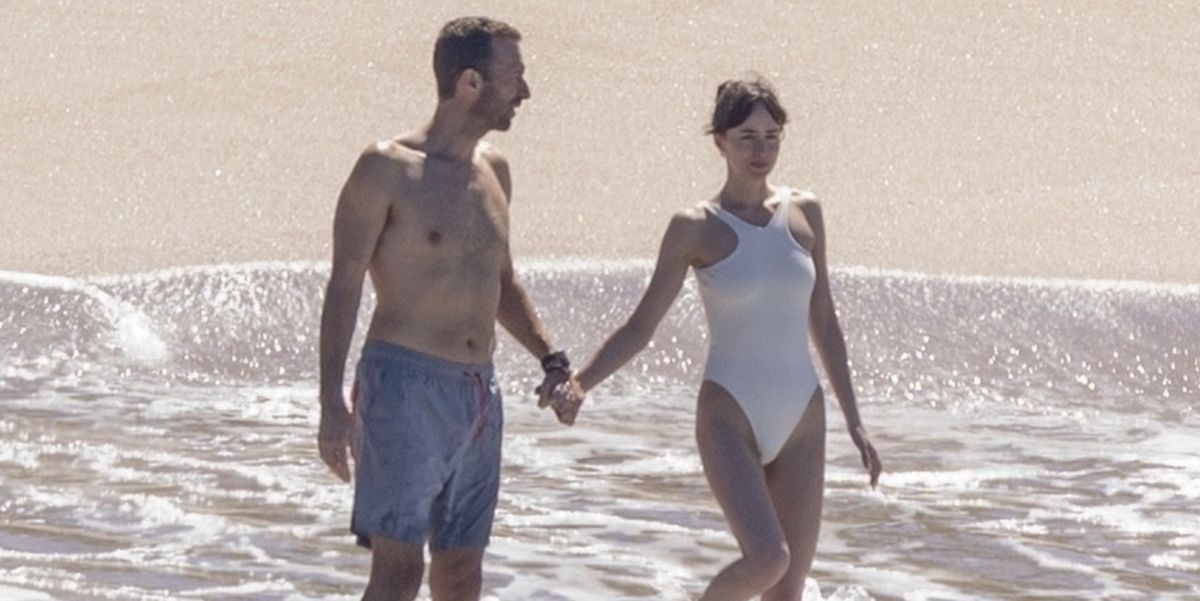Dakota Johnson Wore The Chicest Cream Swimsuit On Vacation With Chris Martin And It’s On Sale