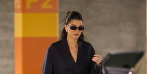 kendall jenner pairs navy suit with an orange bag