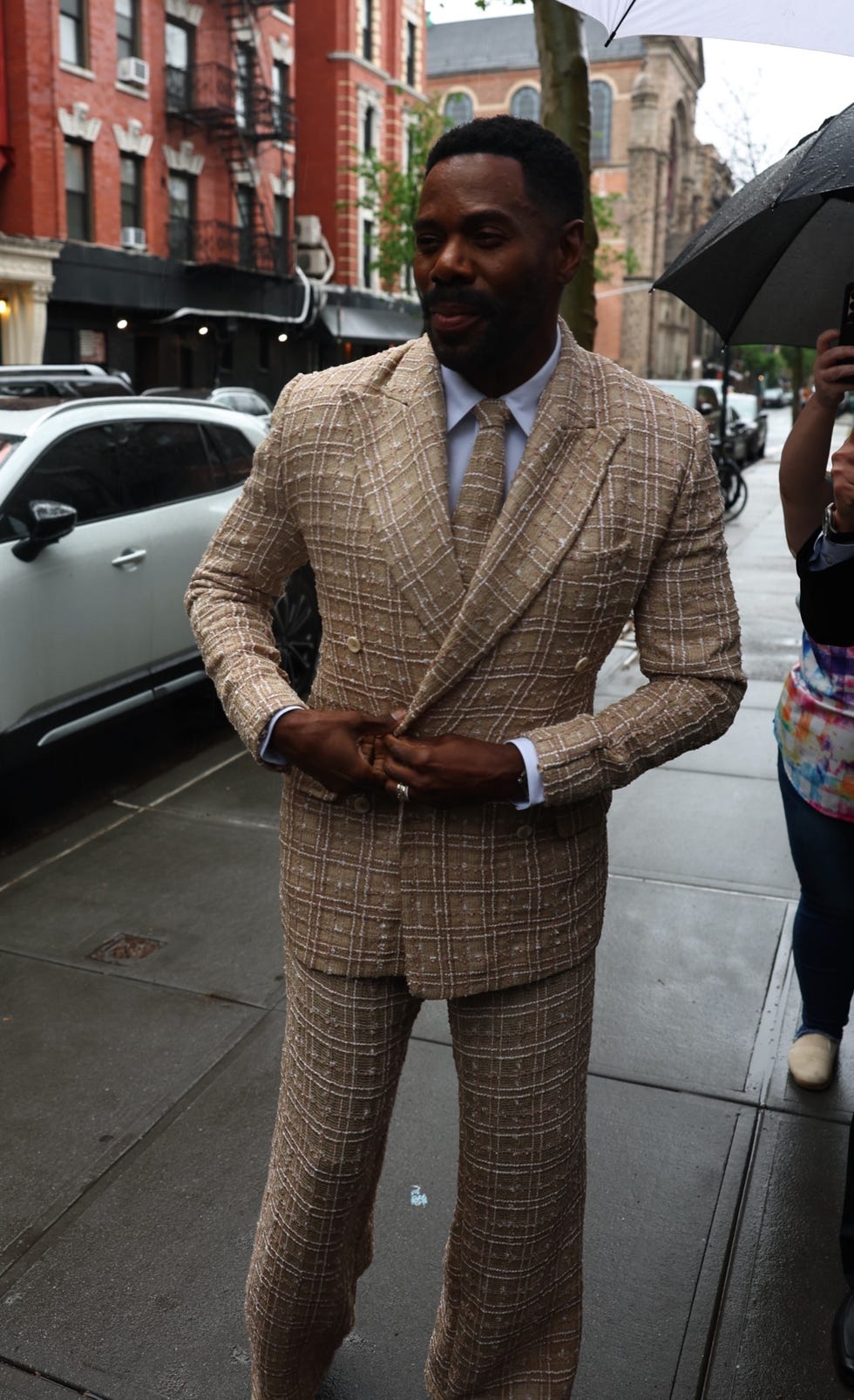 Colman Domingo a person in a checkered beige suit on a city street