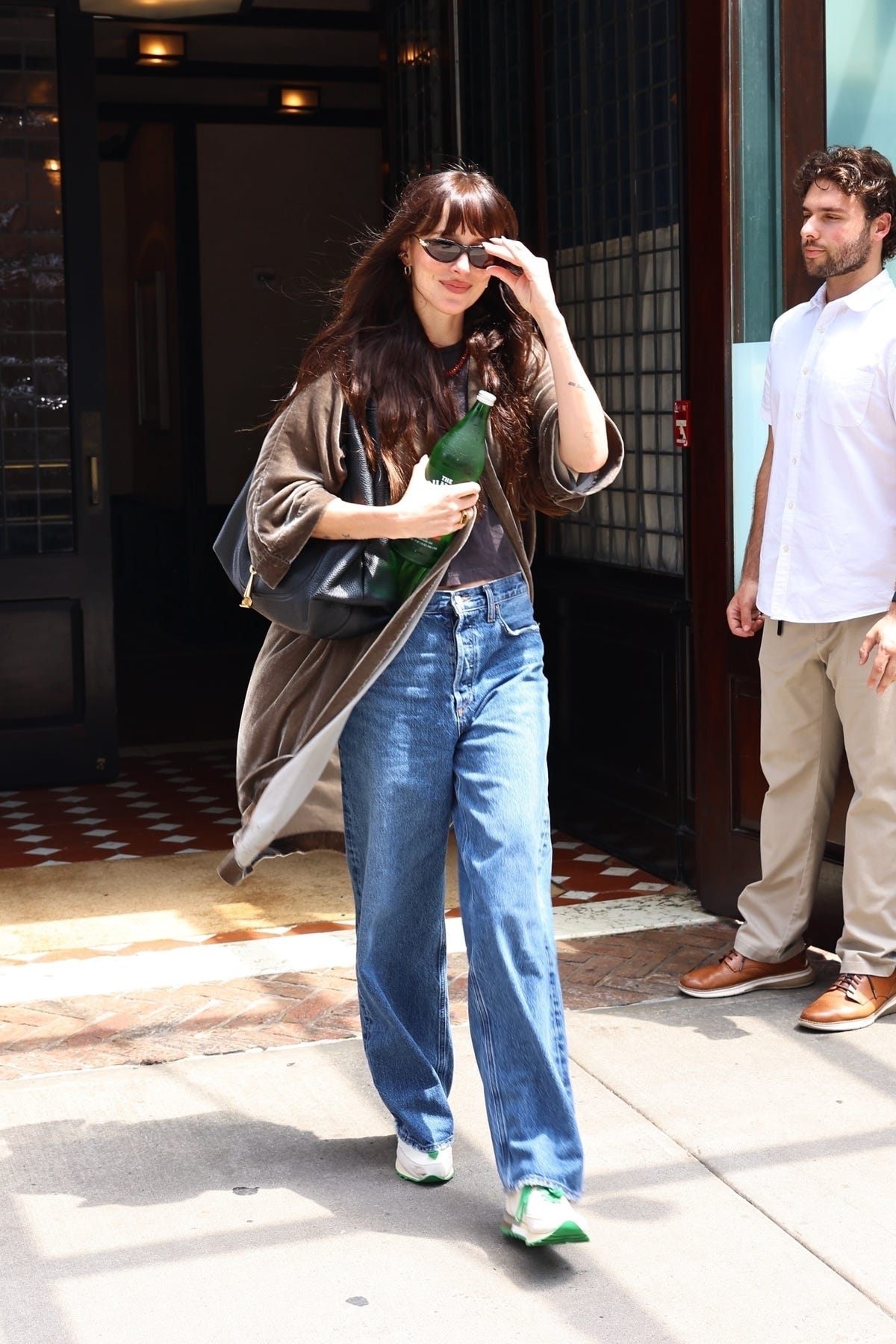 Dakota Johnson’s Off-Duty Look Mixes Dad Sneakers With a Slouchy Gucci Bag