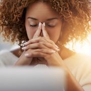bible verses about stress woman with eyes closed and hands folded together in front of face
