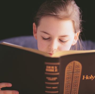 bible verses about children  girl holding and reading the holy bible
