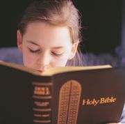 bible verses about children  girl holding and reading the holy bible