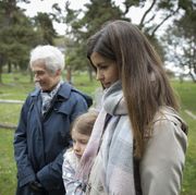 bible verses about death grandma mother and daughter looking at a gravestone in a cemetery