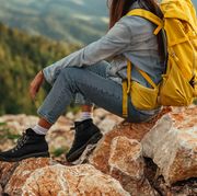 bible verses about fear young female taking a break and sitting on the rocks while hiking through the mountains