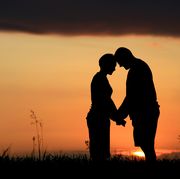 relationship in bible verses  silhouettes of two people holding hands with a sunset in the background