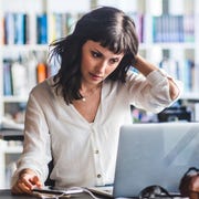 bible verses about worry woman sitting at desk looking at laptop and scratching her head