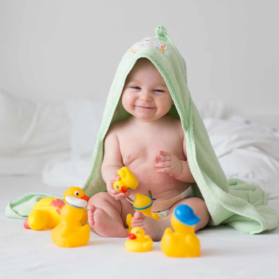 biblical names christian names biblical figure names baby with bath towel on head playing with rubber ducks
