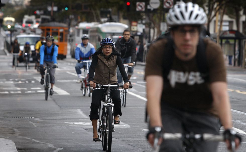 bicycle commuters have room to ride on eastbound market street after traffic was forced to turn right at eighth street in san francisco