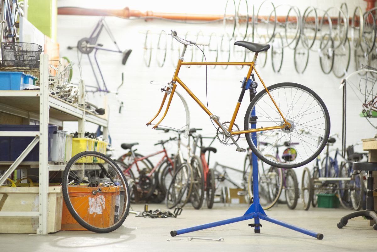 Bicycle on stand in workshop.