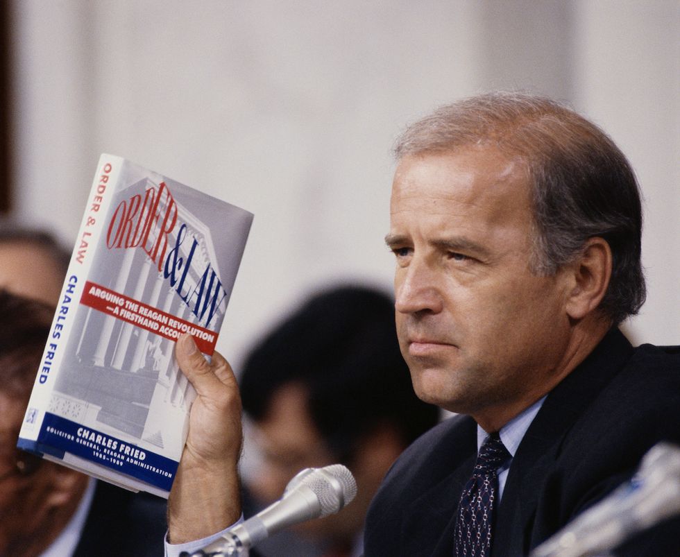 senator joseph biden holds up the book order and law by charles fried during the clarence thomas hearings photo by © wally mcnameecorbiscorbis via getty images