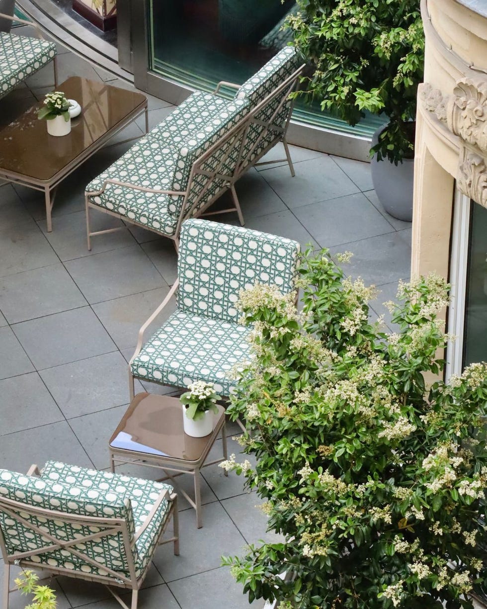 outdoor seating area with patterned chairs and a table