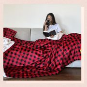 close up of the plush fabric of the sherpa blanket, and a photo of a girl enjoy a cup of coffee and a book under the large blanket