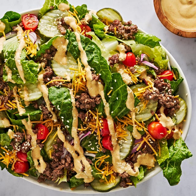 big mac salad with big mac sauce, cherry tomatoes, ground beef, and pickles