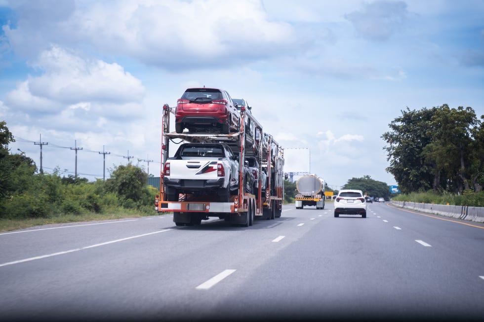 big trucks, powerful new car moving trucks ship to distributor shipping is moving on the road