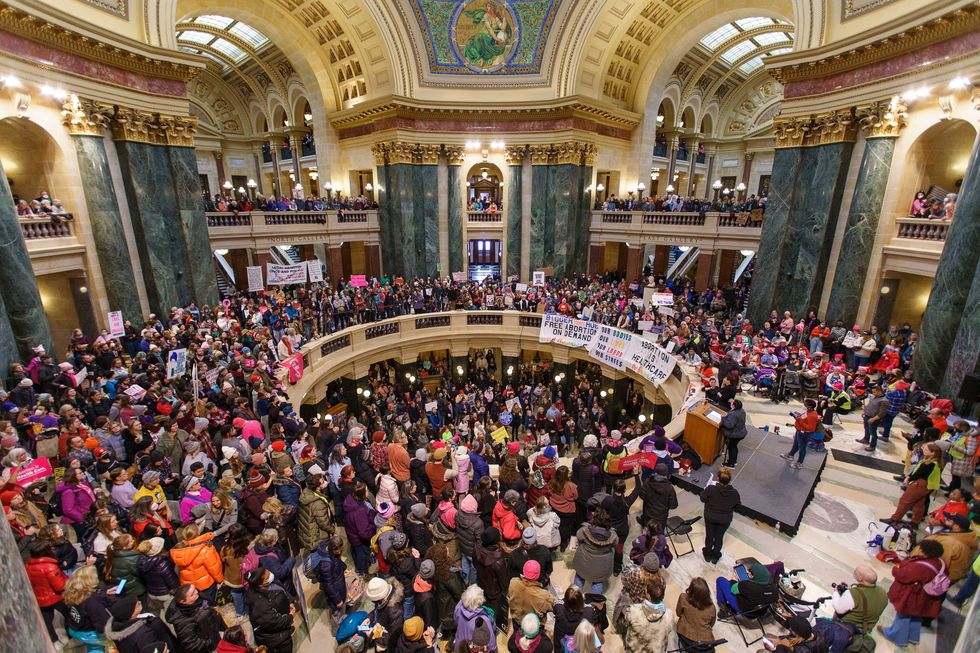 abortion rights supporters rally at the bigger than roe national mobilization march in the rotunda of the capital in madison
