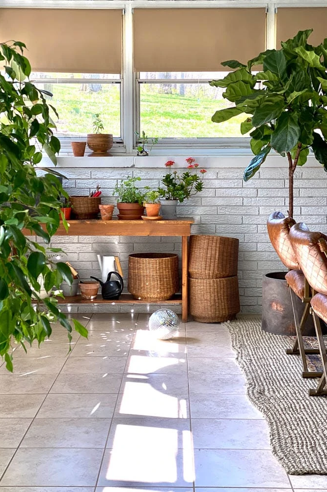 sunroom ideas like potting bench with plants and baskets