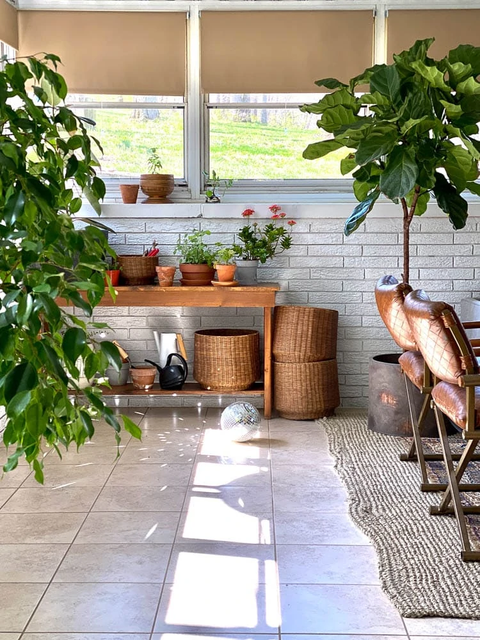 sunroom ideas like potting bench with plants and baskets