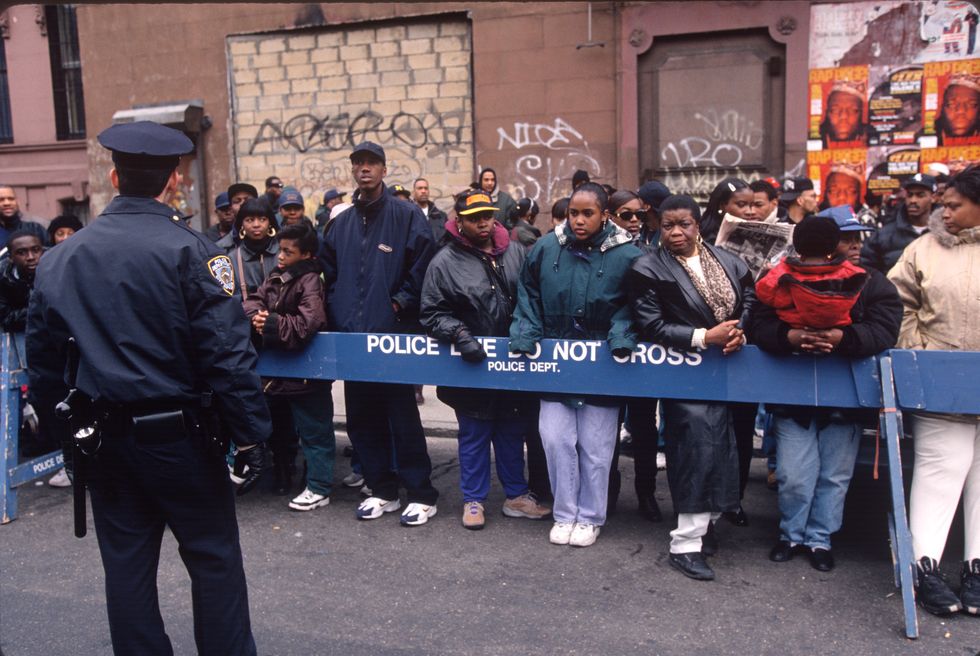 The Clinton Hill neighborhood where the rap star Christopher Wallace grew up, comes out to watch his funeral procession drive by on March 18, 1997, in the Brooklyn.