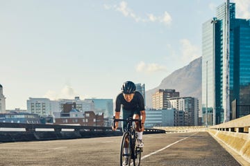 bike, road and mock up with a woman cycling on a bridge in the city for cardio or endurance exercise bicycle, street and fitness with a female cyclist or athlete riding outdoor on an urban background