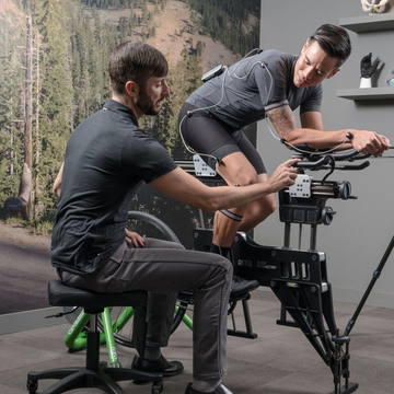 bike fitter and cyclist on stationary bike bike fitter and cyclist on stationary bike
