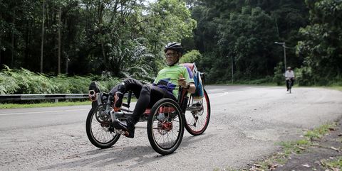 a muslim senior man is riding bike to fill in retirement days