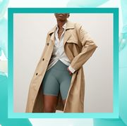 woman in biker shorts and trench coat
