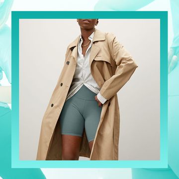 woman in biker shorts and trench coat