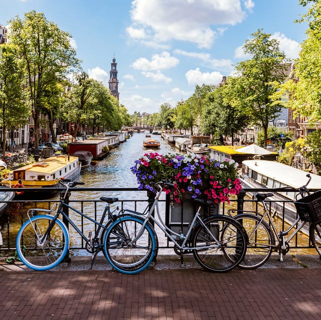 bikes by the canal on a sunny summer day in amsterdam, netherlands