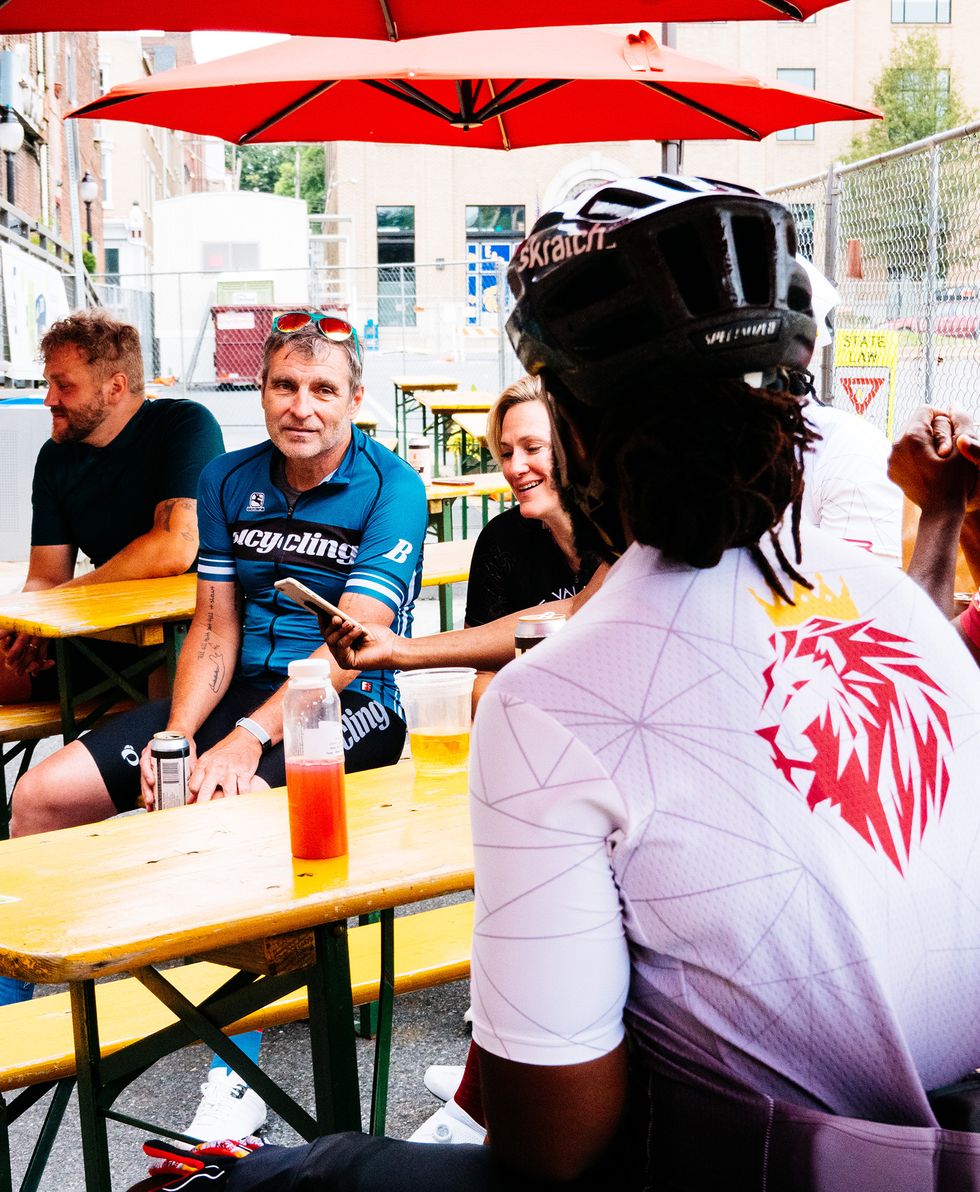 bill strickland with cyclists at a cafe