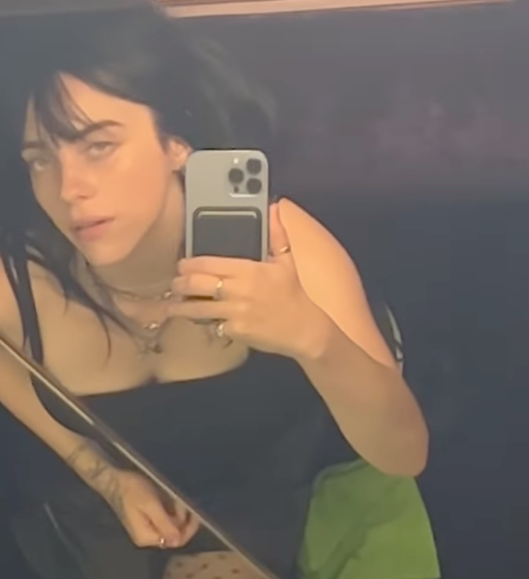 Billie Eilish wears a lace slip with a thigh slit