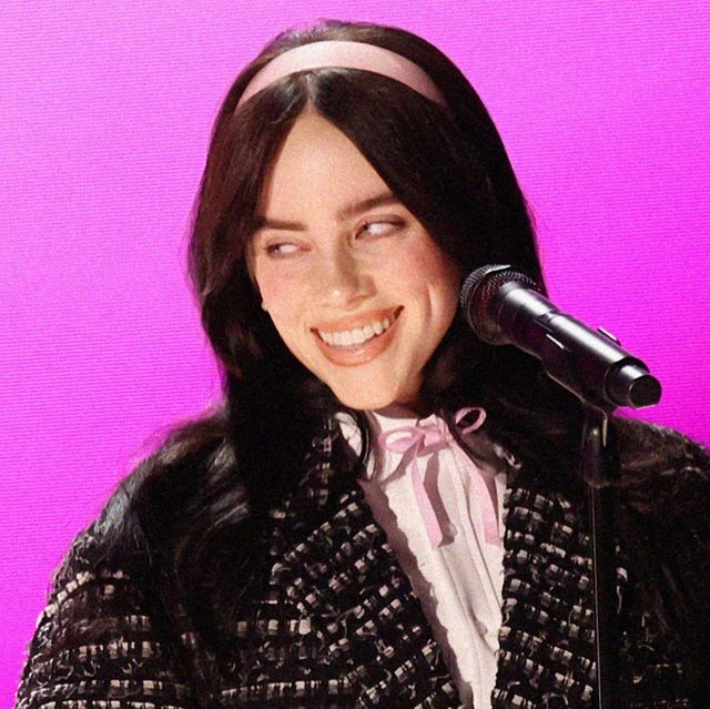 singer billie eilish smiling with a microphone