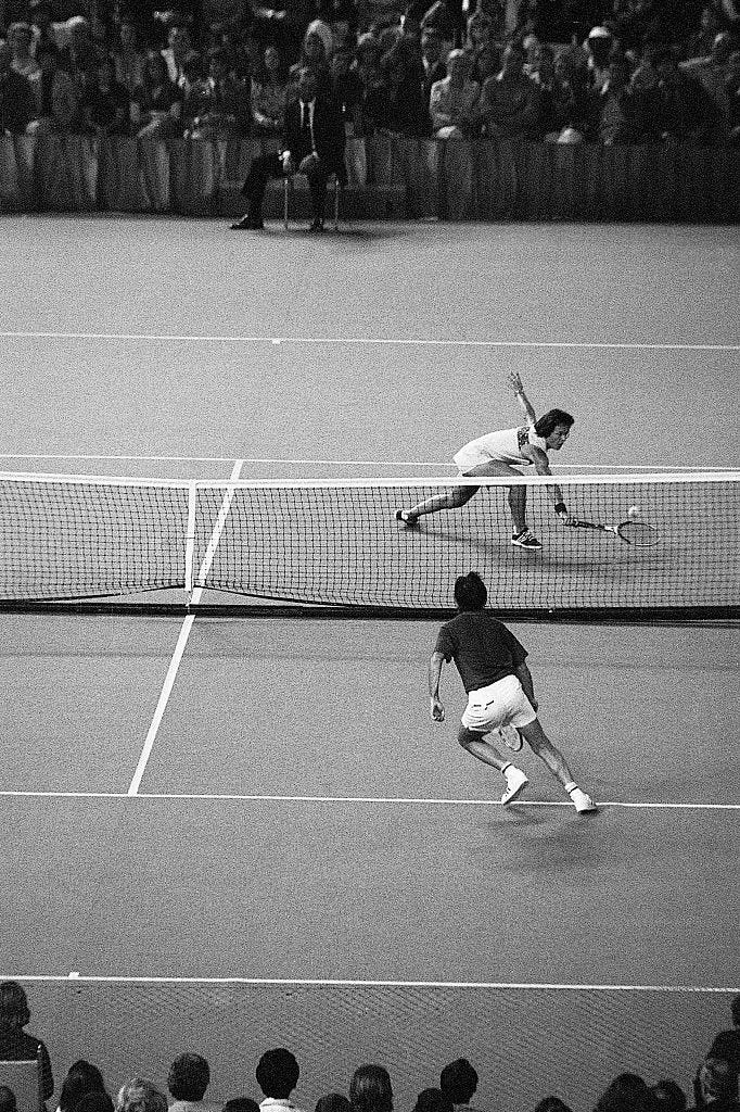 billie jean king reaches for a low volley as bobby riggs runs left as he watches his opponent