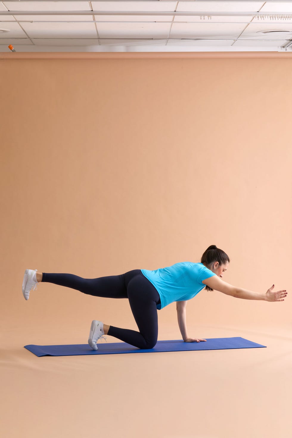 A person performing an exercise on a yoga mat